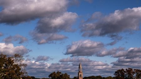 Long-range aerial image of Morehead-Patterson Bell Towr on a partly cloudy afternoon on the campus of U.N.C Chapel Hill.