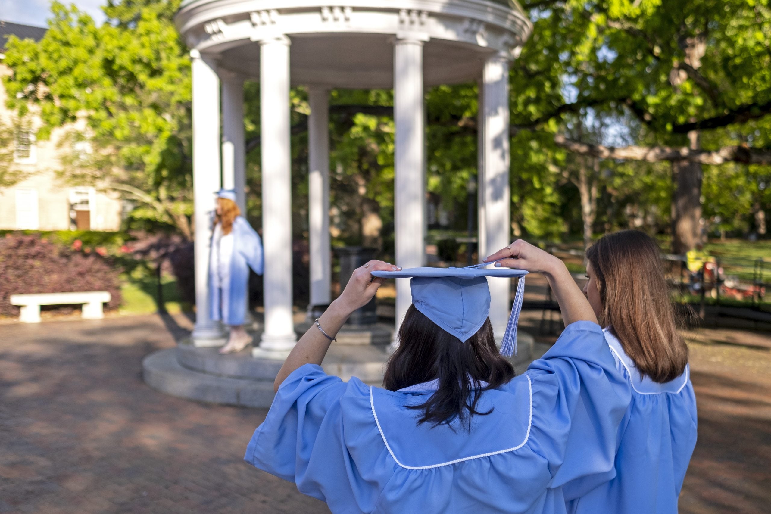 Student at UNC-Chapel Hill holding up a sticker that says 