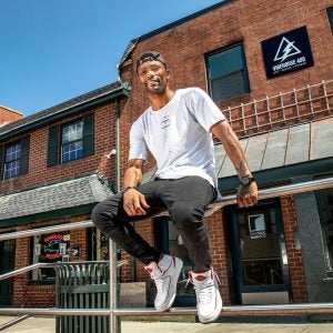 Kevin Thomas sits on a handrailing on Franklin Street.