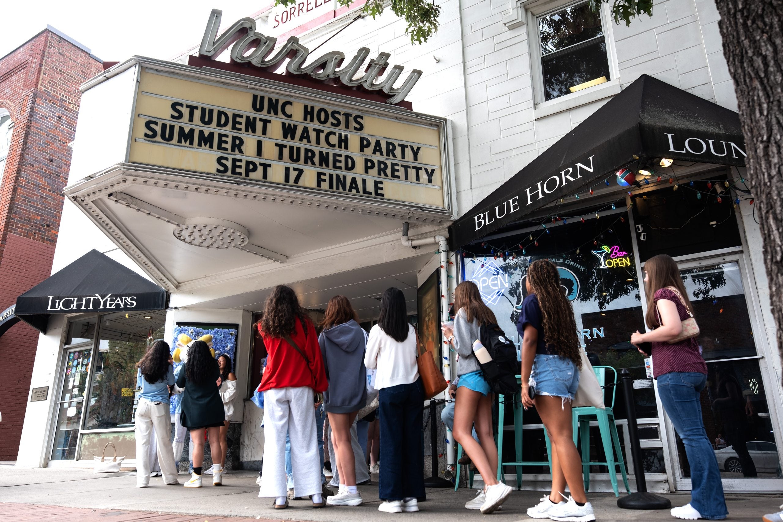 Students wait outside the Varsity Theatre to get prime seating for the watch party.