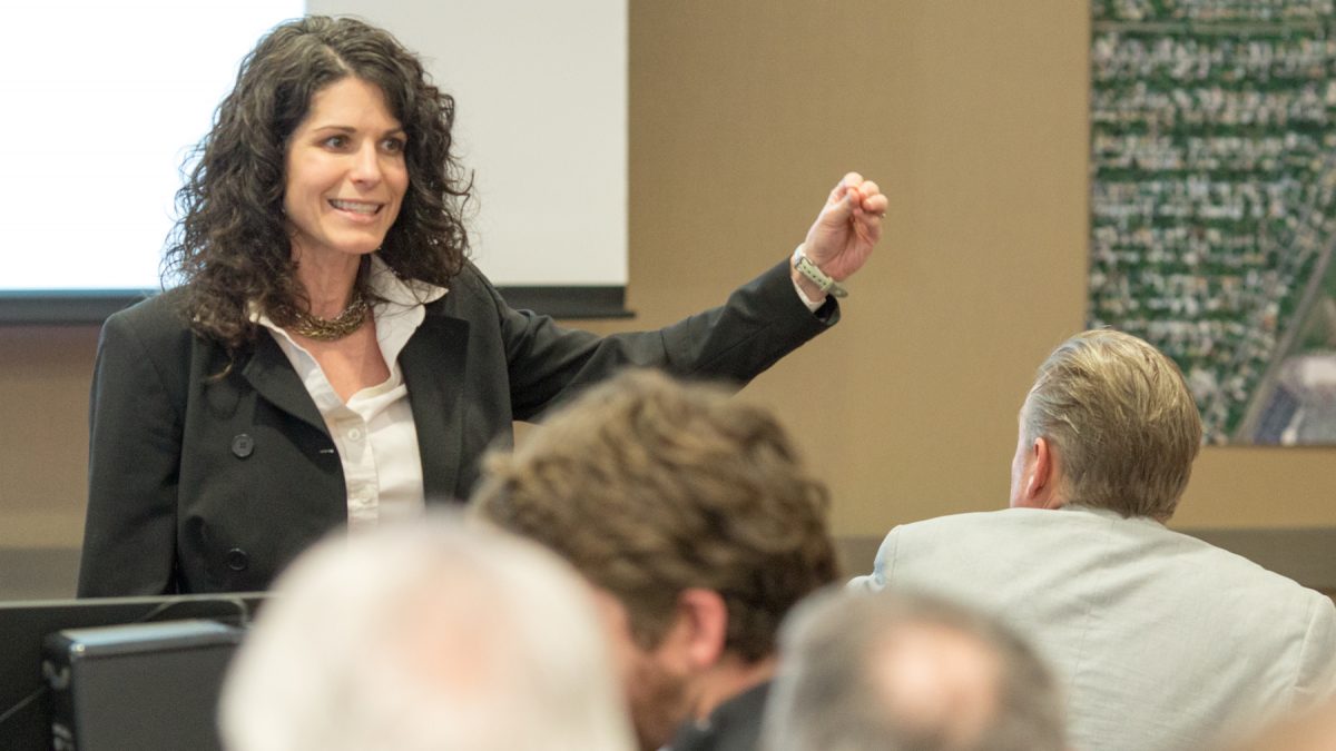 Instrucor Kara Millonzi gestures to a class.