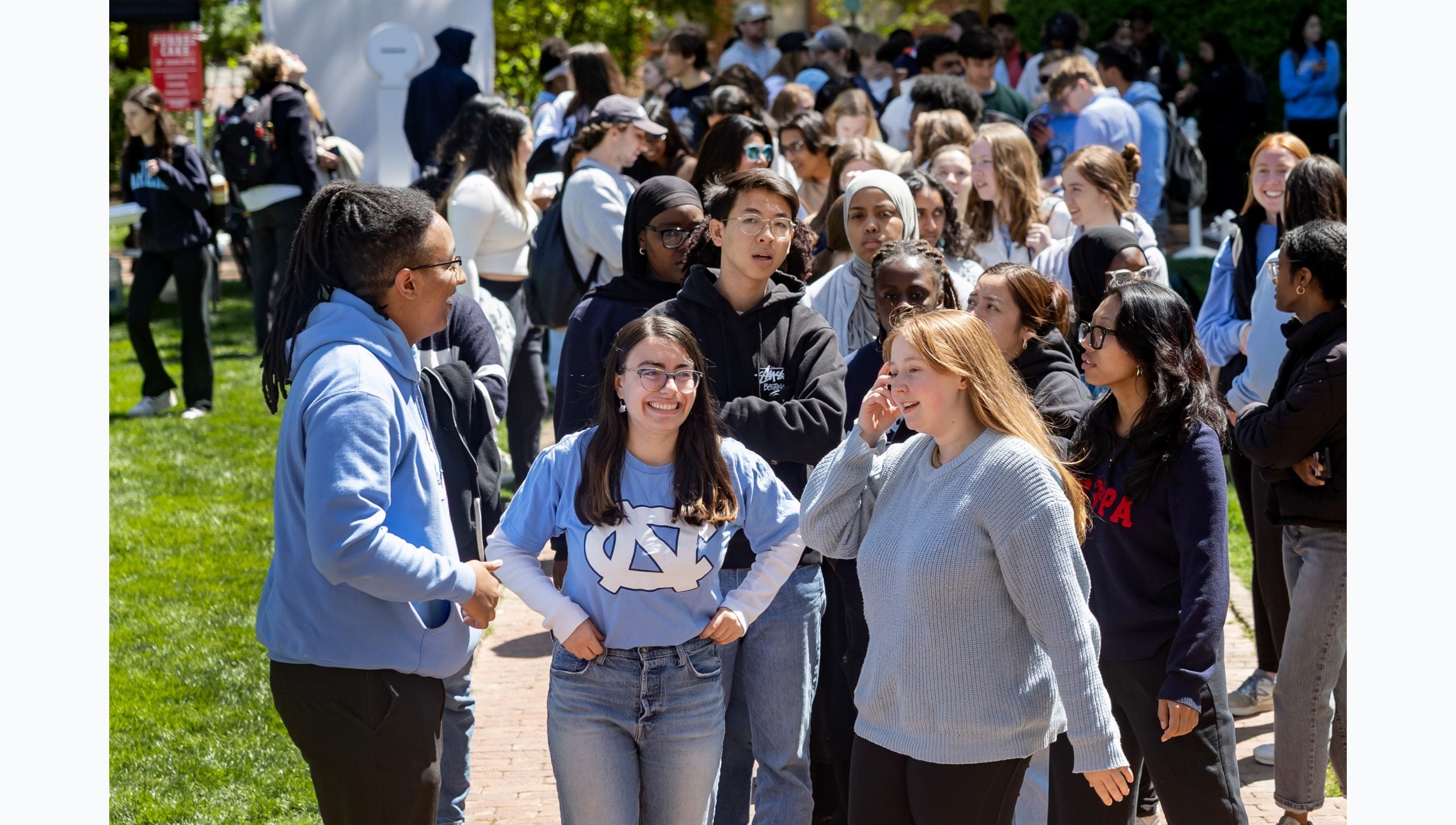 Large group of UNC-Chapel Hill students talking while in line to climb the Bell Tower.