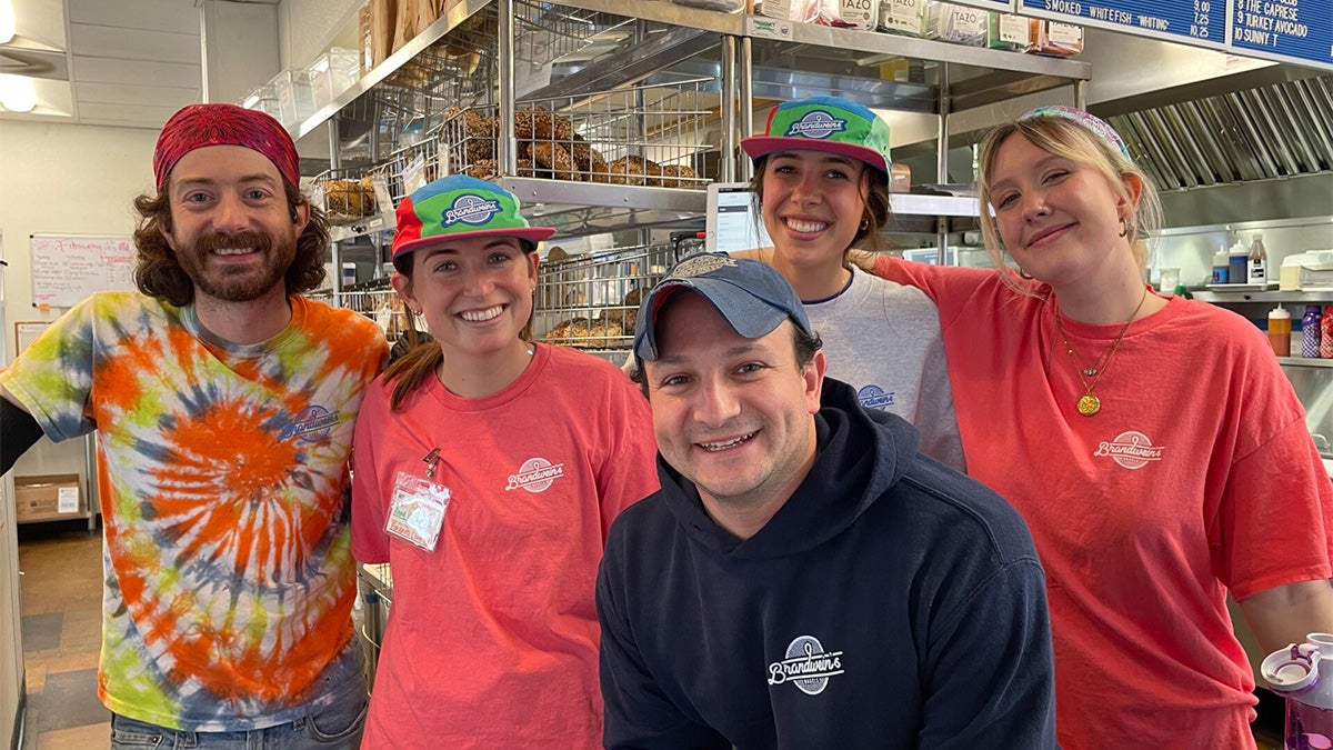 The staff of Brandwein's Bagels posing for a group photo in the shop.