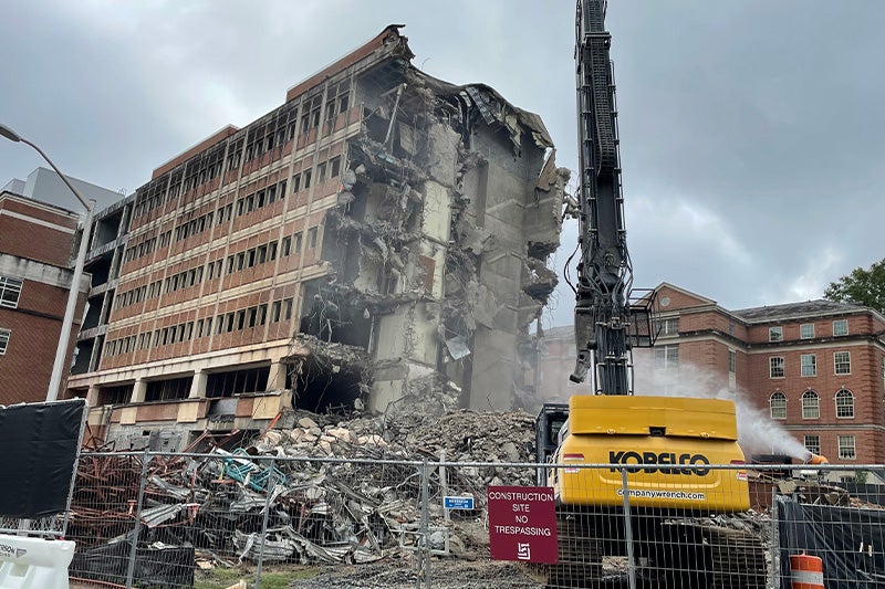 Wing of a nursing building on the campus of UNC-Chapel Hill being destroyed.