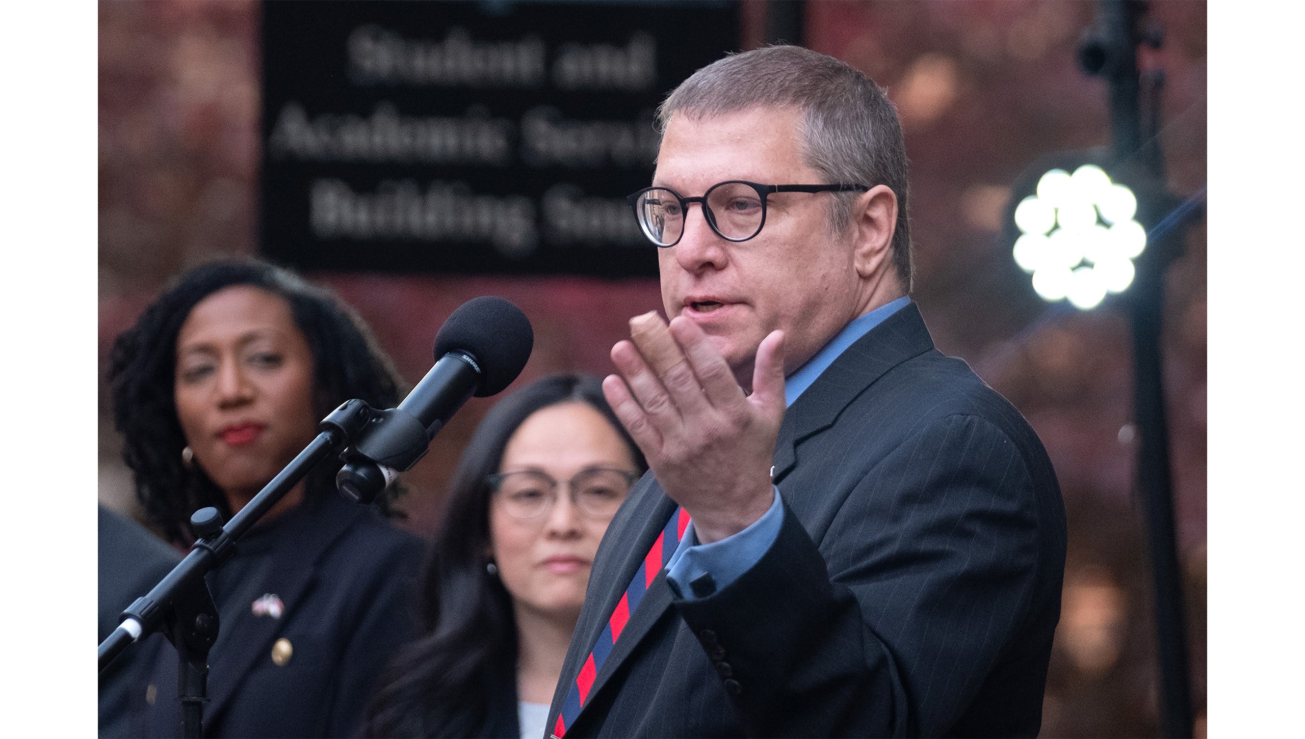 Rob Palermo speaking into a microphone at a podium at the opening of the UNC-Chapel Hill Military and Veteran Student Success Center.