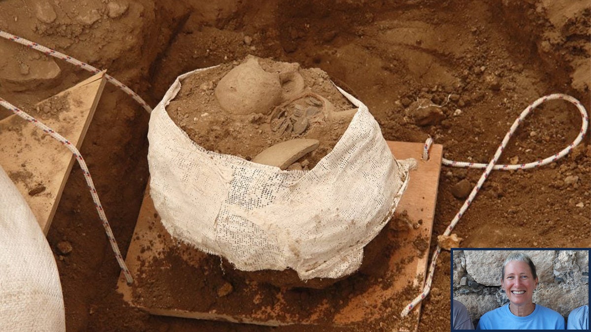A jug of coins encrusted in dirt at the Huqoq dig site. In the bottom corner of the image is a separate cutout image of a woman, Jodi Magness.
