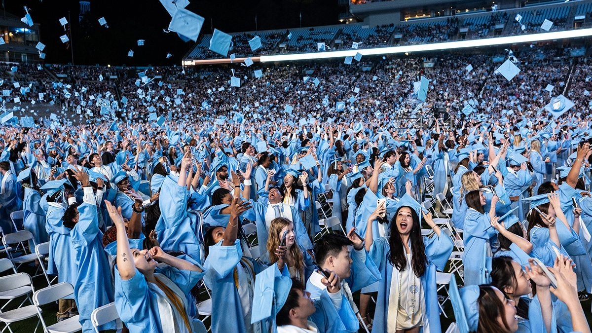 Carolina graduates toss their caps during 2025 Spring Commencement at Kenan Stadium.