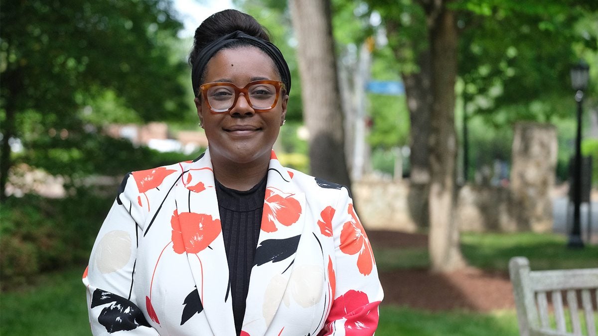 Constance Lindsay poses for a photo in front of the Davie Poplar tree on U.N.C. campus.