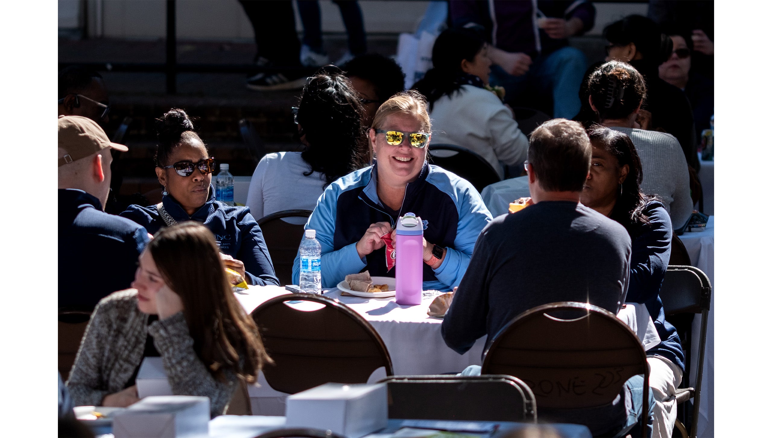 UNC-Chapel Hill employees talking and eating during a lunch in the Pit.