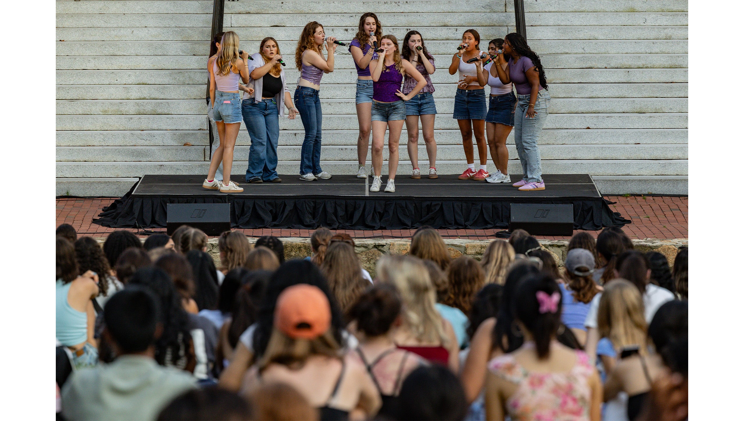 A cappella group performing on stage in front of Wilson Library on the campus of UNC-Chapel Hill at Sunset Serenade.