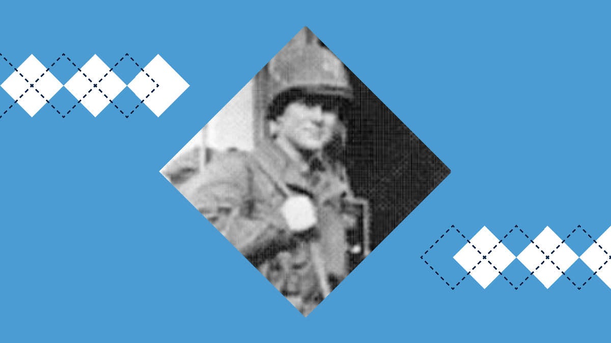 Staff Sgt. Lawrence Flinn poses for a photo while wearing his military uniform and carrying supplies.