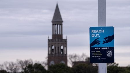 In the foreground, the new 'reach out' sign with the U.N.C. Bell Tower in the background.
