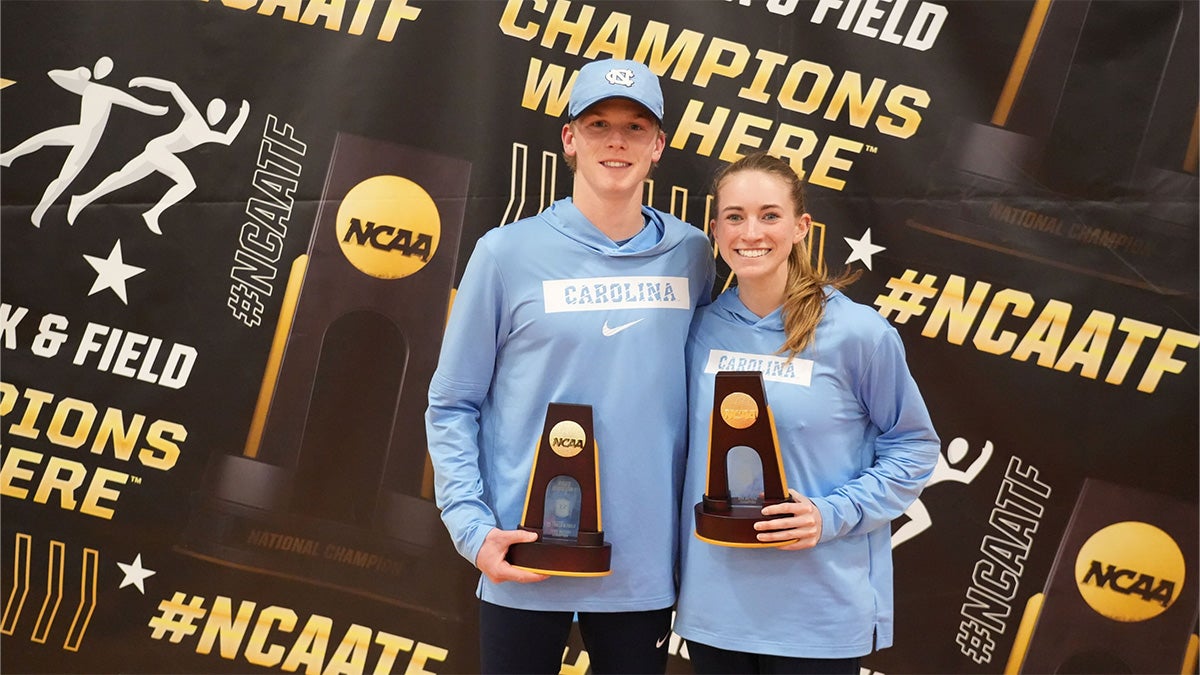 Ethan Strand and Makayla Paige of UNC track and field posing for a photo together with their national championship trophies.