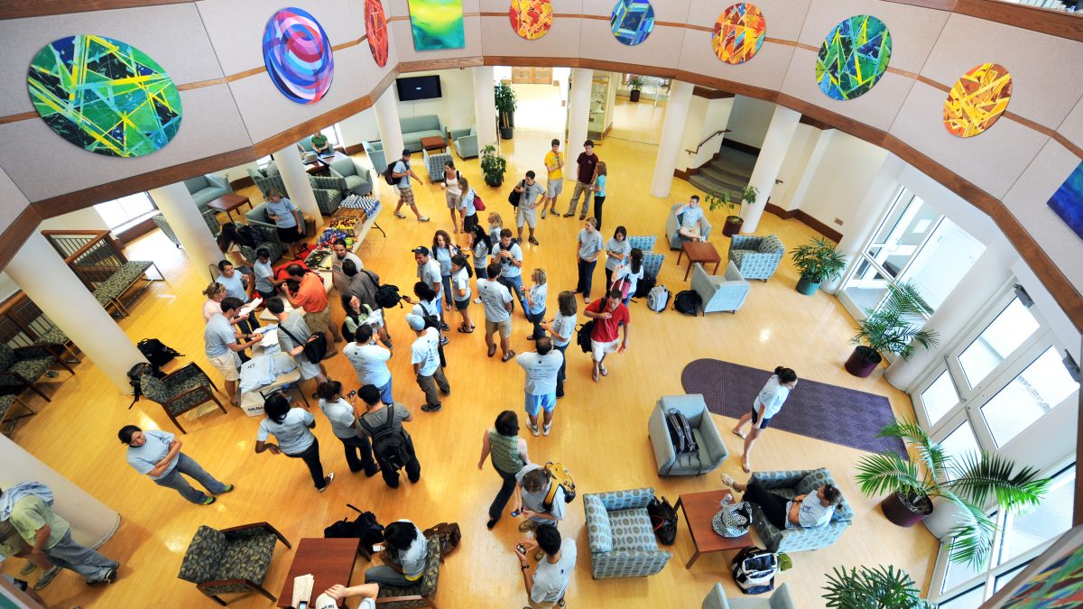 Students, faculty and staff gather in the law school rotunda.
