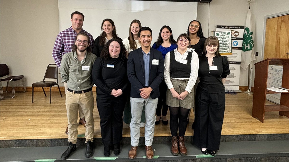 Group of individuals posing in classroom.