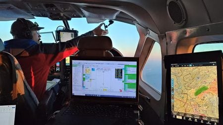 Pilot in helicopter cockpit.