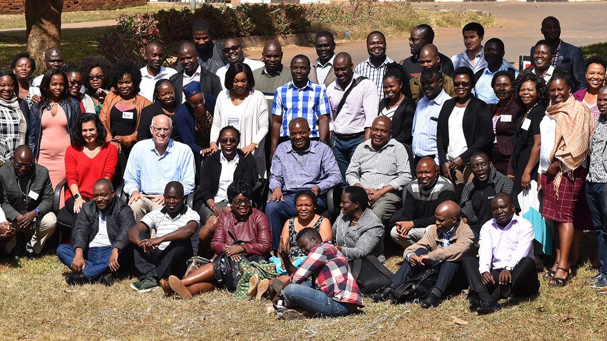 The Friendship Bench team gathers for a photo outdoors.