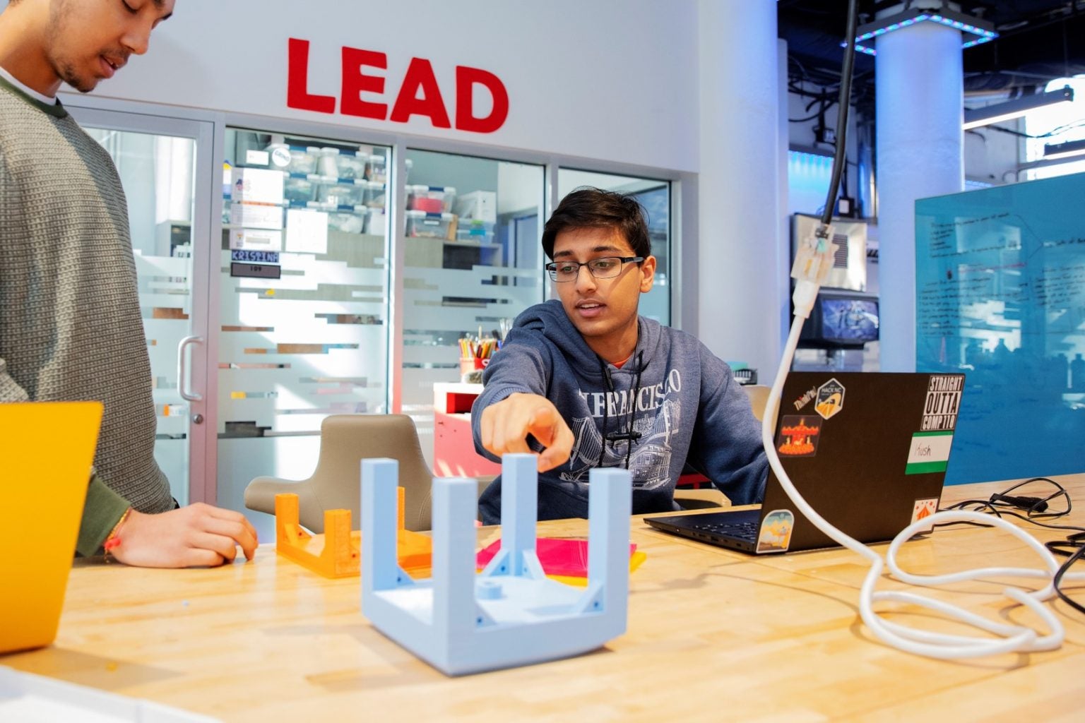 QUVI founders Kush Jain (right) and Harshul Makwana (left) working on their initial water bottle sanitation prototype for the UNC Makeathon.
