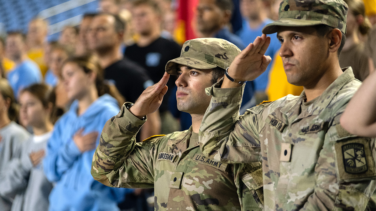 Army members saluting during National Anthem at Carolina's 9/11 Memorial Climb.