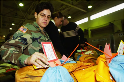 Lt. Col. Tanya Bradsher sorts supplies while wearing her U.S. Army uniform.