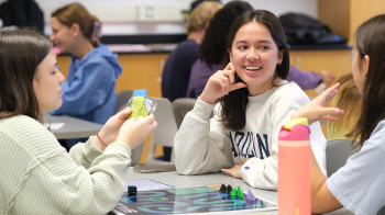 Students conversing at a table.